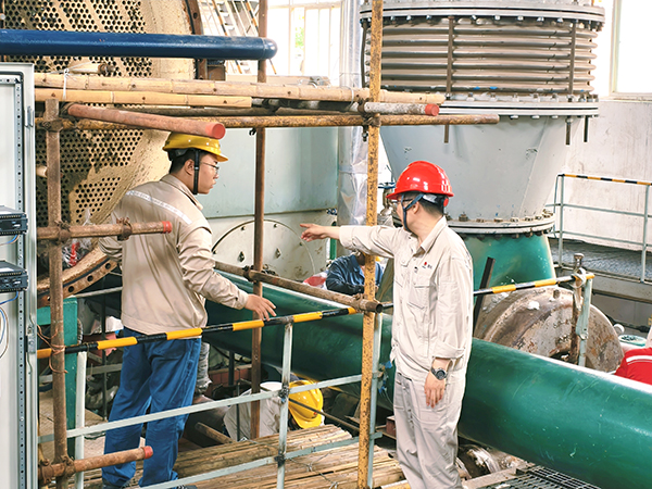 7月5日，清理凝汽器现场，副主任秦昊正在叮嘱青工贺国庆注意事项.jpg